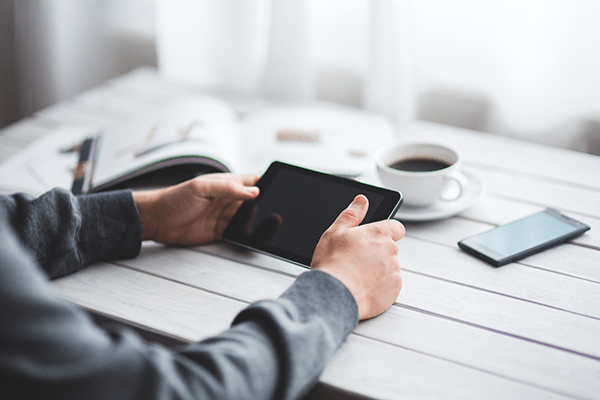 hands holding a tablet