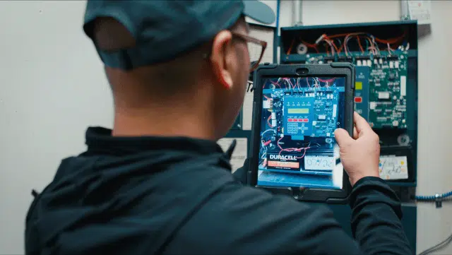 A commercial service professional uses ServiceTrade software