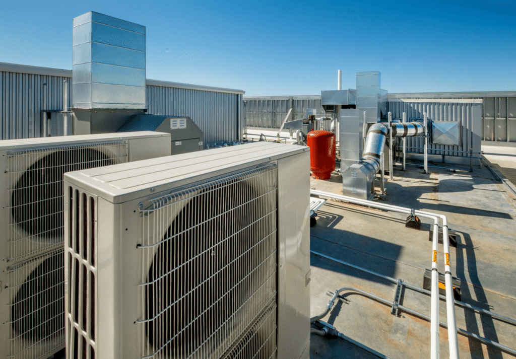 Rooftop hvac condensing units and ductwork under a blue sky