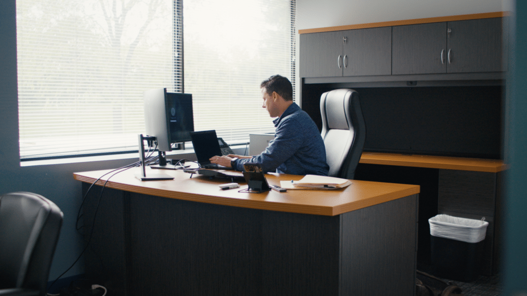 Man sitting at computer looking at data